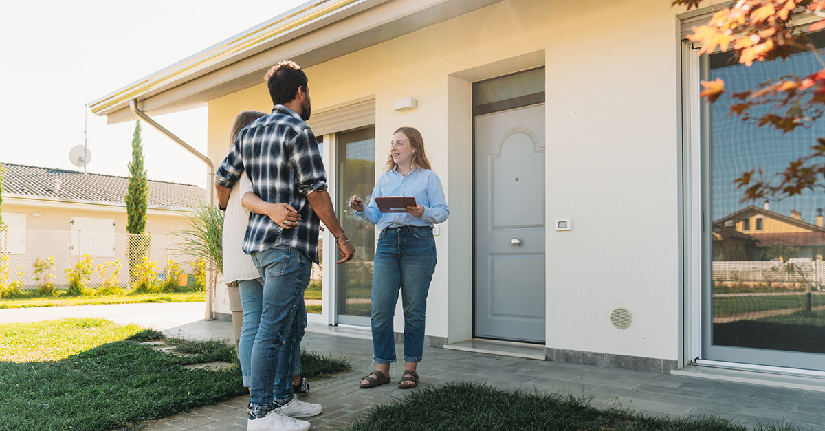 An agent showing a home to a couple